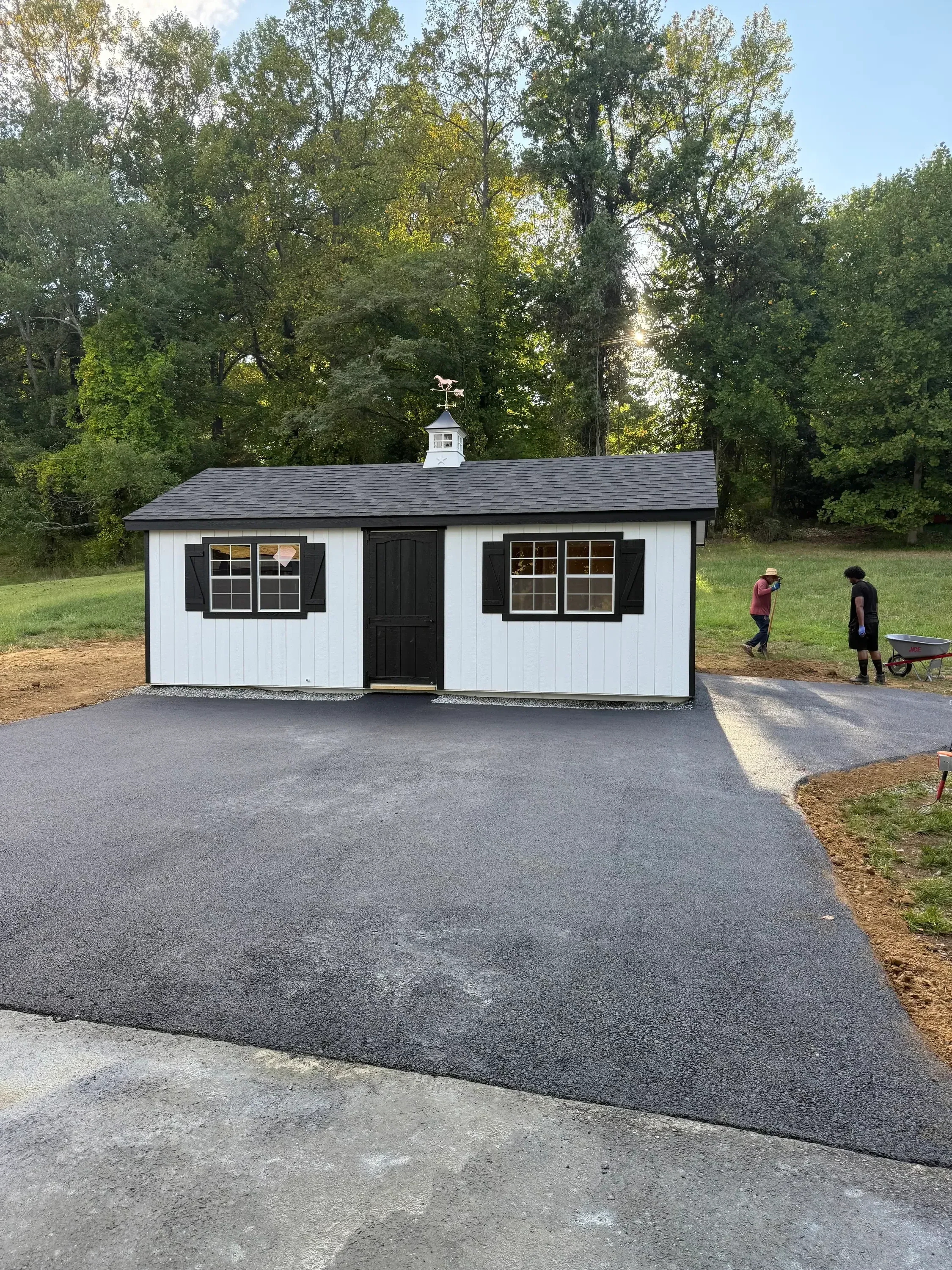 New asphalt driveway with smooth dark surface installed at residential home